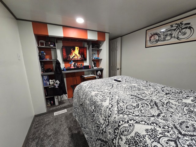 bedroom with dark colored carpet