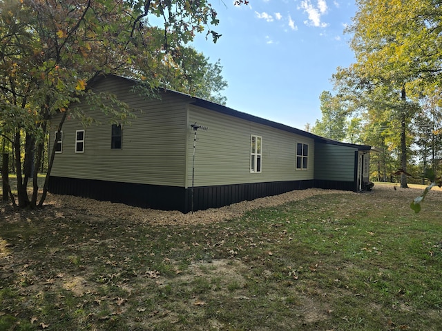 view of property exterior with a yard