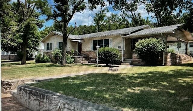 ranch-style house featuring a front yard