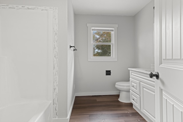 full bathroom featuring shower / tub combo with curtain, vanity, hardwood / wood-style flooring, and toilet