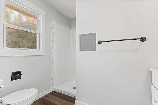 bathroom featuring hardwood / wood-style floors, vanity, a shower, and toilet