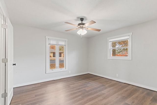 empty room with ceiling fan and hardwood / wood-style floors