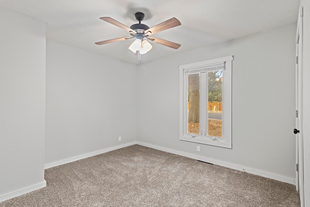 empty room featuring ceiling fan and carpet flooring