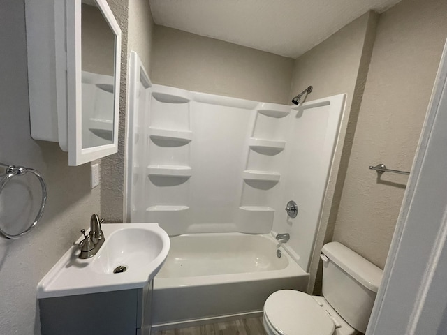 824 W Elm St, Springfield, MO 65806 - bathroom featuring a textured wall, shower / bathtub combination, vanity, and wood finished floors