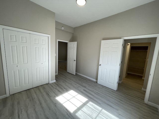 824 W Elm St, Springfield, MO 65806 - unfurnished bedroom with wood finished floors and a closet
