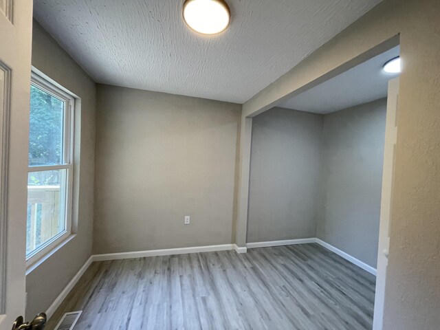 824 W Elm St, Springfield, MO 65806 - spare room featuring wood finished floors and a textured ceiling