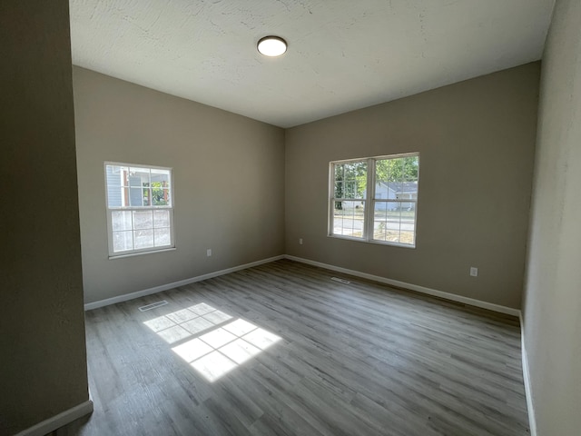 824 W Elm St, Springfield, MO 65806 - spare room featuring wood finished floors and baseboards
