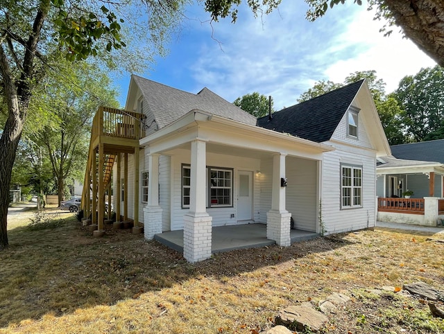 824 W Elm St, Springfield, MO 65806 - view of side of home with covered porch and roof with shingles
