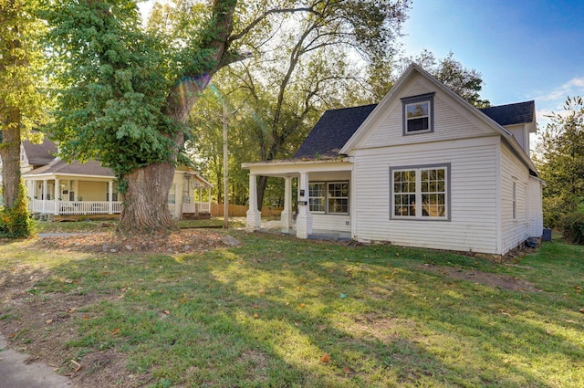 824 W Elm St, Springfield, MO 65806 - view of front of house featuring a porch, a front yard, and roof with shingles