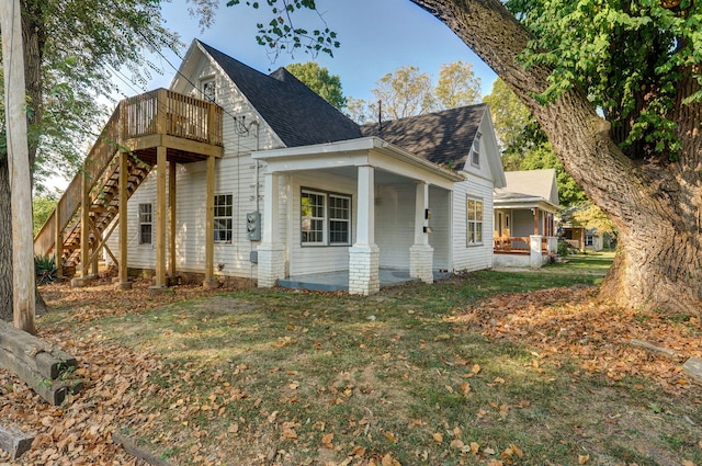 824 W Elm St, Springfield, MO 65806 - view of side of home featuring a shingled roof, stairway, a porch, and a yard