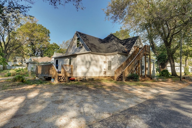 824 W Elm St, Springfield, MO 65806 - view of side of home with stairway and a wooden deck