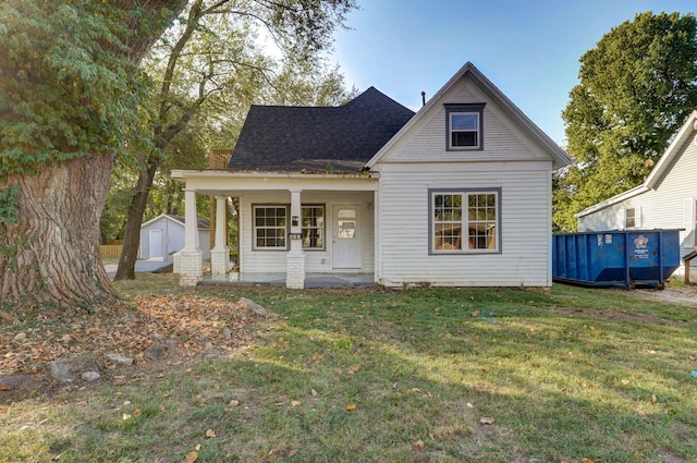 824 W Elm St, Springfield, MO 65806 - bungalow-style home with a front yard, covered porch, and a storage unit