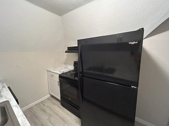 824 W Elm St, Springfield, MO 65806 - kitchen featuring black appliances, lofted ceiling, custom range hood, light wood finished floors, and a textured ceiling