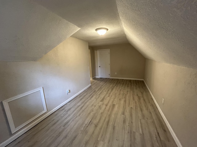 824 W Elm St, Springfield, MO 65806 - bonus room with a textured ceiling, wood finished floors, and lofted ceiling