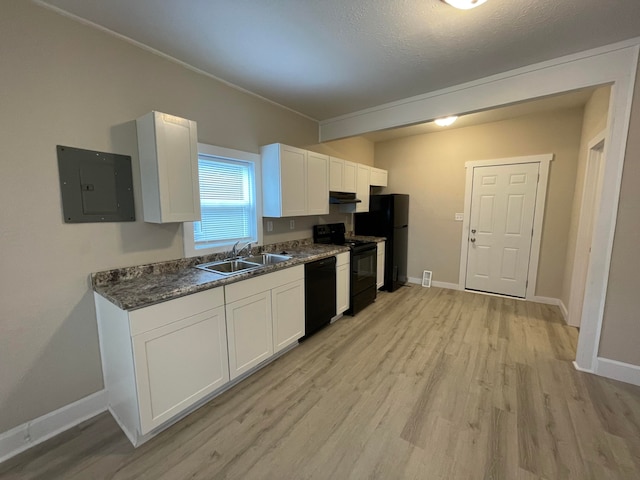 kitchen with electric panel, light wood-type flooring, sink, black appliances, and white cabinetry