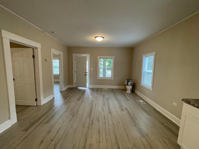 foyer featuring light hardwood / wood-style floors and ornamental molding