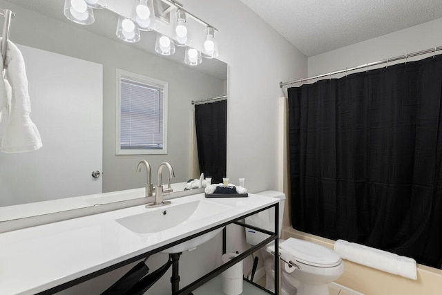 full bathroom featuring vanity, shower / bath combination with curtain, a textured ceiling, and toilet