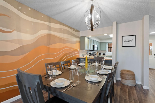 dining room featuring wood-type flooring, an inviting chandelier, and a textured ceiling