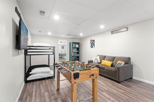 rec room with a paneled ceiling and hardwood / wood-style flooring