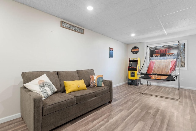 living room with a paneled ceiling and hardwood / wood-style floors