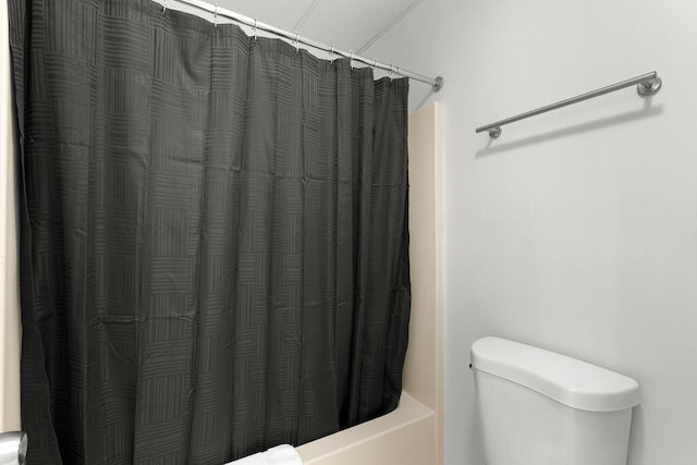 bathroom with toilet and shower / bathtub combination with curtain