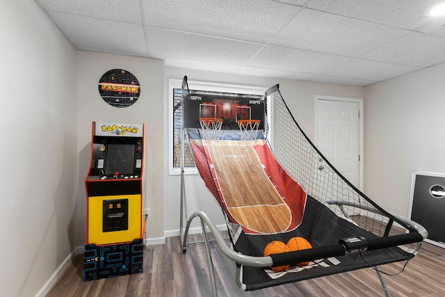 game room with hardwood / wood-style flooring and a paneled ceiling