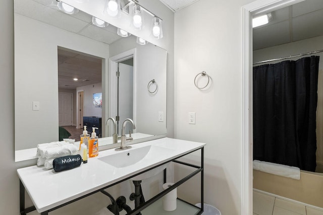 bathroom featuring curtained shower, tile patterned floors, and vanity