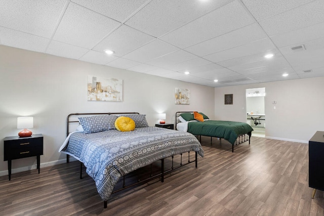 bedroom with dark wood-type flooring and a paneled ceiling