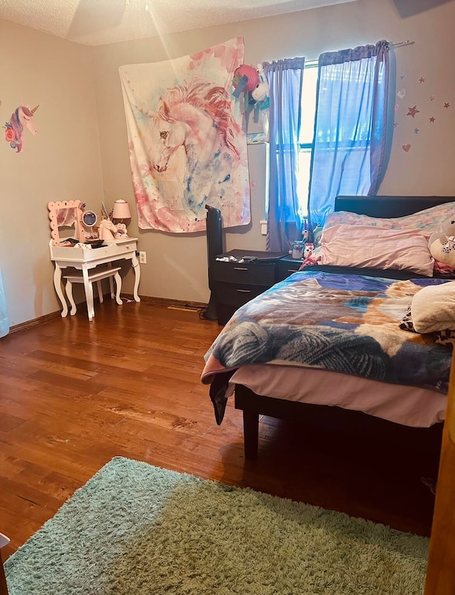 bedroom featuring a textured ceiling and hardwood / wood-style flooring