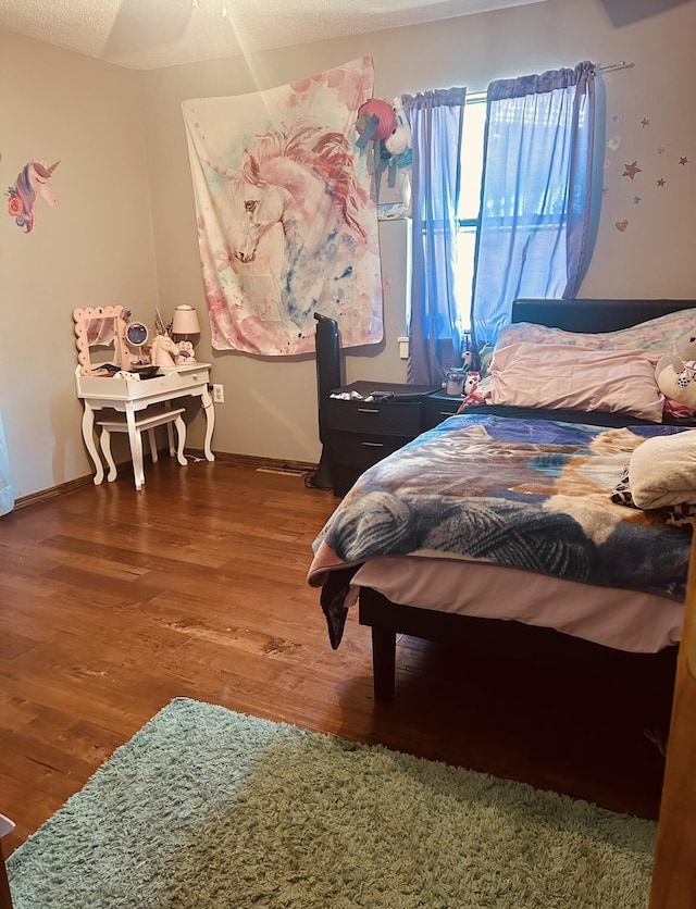 bedroom featuring wood finished floors