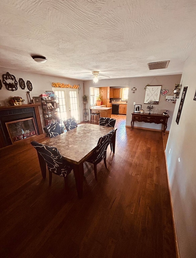 dining room featuring hardwood / wood-style floors, a textured ceiling, and french doors