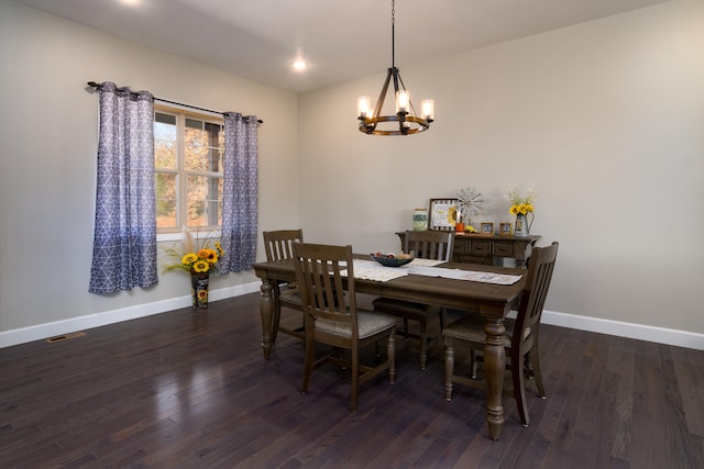 dining space with a chandelier and dark hardwood / wood-style flooring