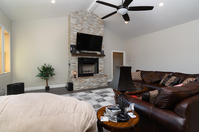 living room featuring ceiling fan, hardwood / wood-style floors, vaulted ceiling with beams, and a stone fireplace