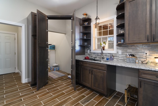 kitchen with dark brown cabinets, decorative light fixtures, and dark hardwood / wood-style flooring