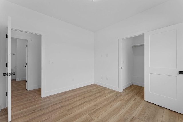 unfurnished bedroom featuring a closet and light hardwood / wood-style floors