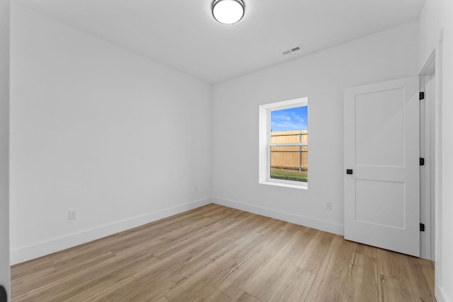 unfurnished room with light wood-type flooring