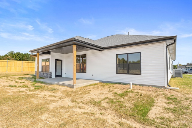 rear view of house featuring a yard and a patio