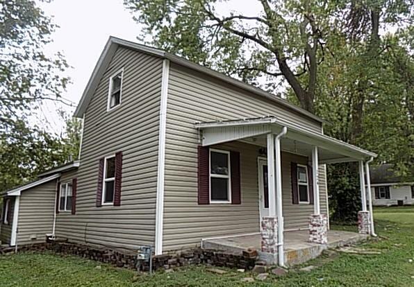 view of property exterior with a lawn