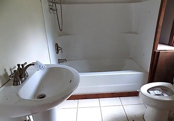 full bathroom with tile patterned floors, sink,  shower combination, and toilet