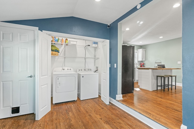 washroom featuring washer and dryer and hardwood / wood-style flooring