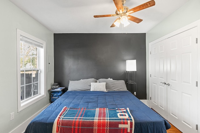 bedroom featuring hardwood / wood-style flooring, ceiling fan, and a closet