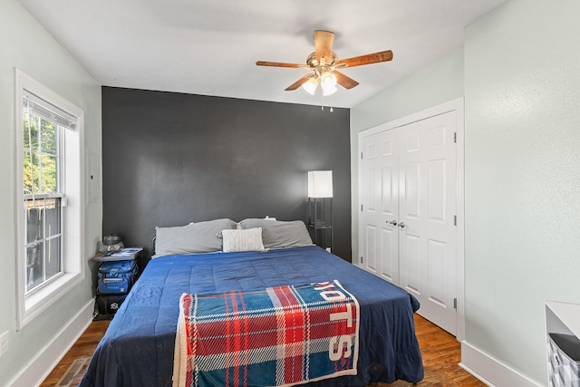 bedroom with ceiling fan, a closet, and dark hardwood / wood-style flooring