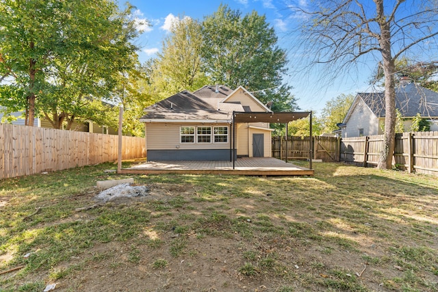 rear view of property featuring a yard and a wooden deck