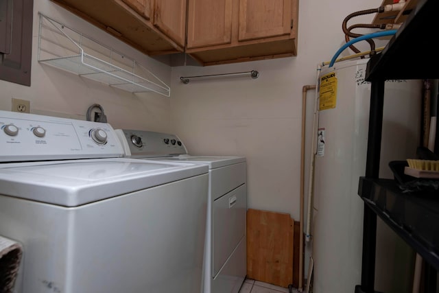 clothes washing area featuring gas water heater, washing machine and dryer, cabinets, and light tile patterned floors