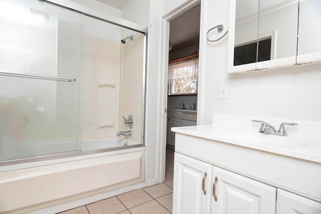 bathroom with enclosed tub / shower combo, vanity, and tile patterned floors