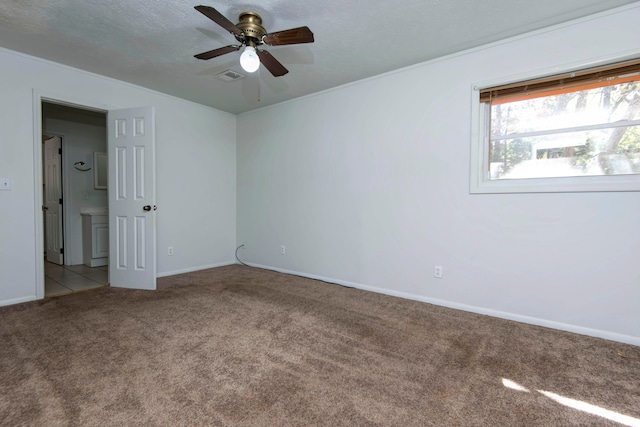 spare room with light carpet, ceiling fan, and a textured ceiling