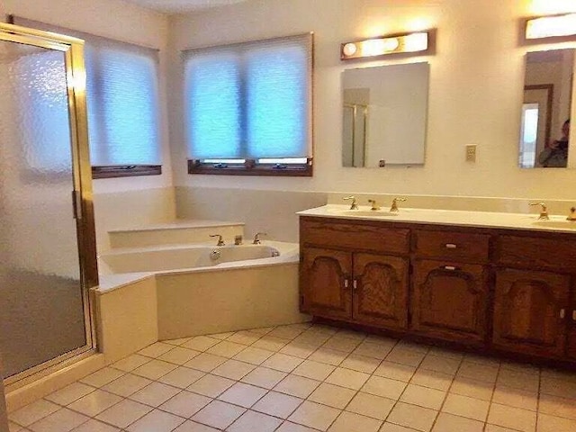 bathroom featuring shower with separate bathtub, tile patterned floors, and vanity