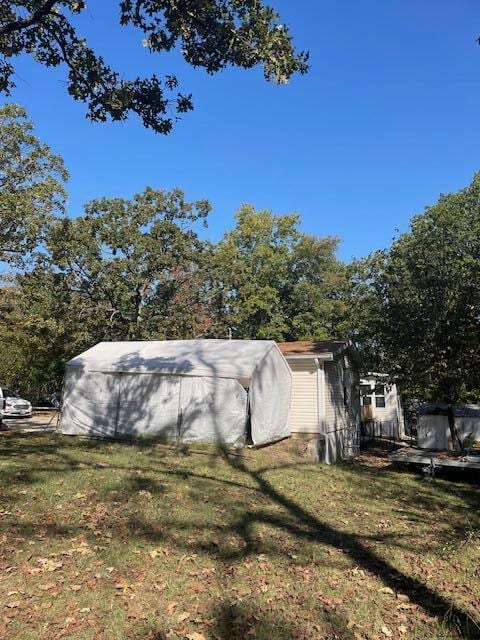 view of side of home with a lawn