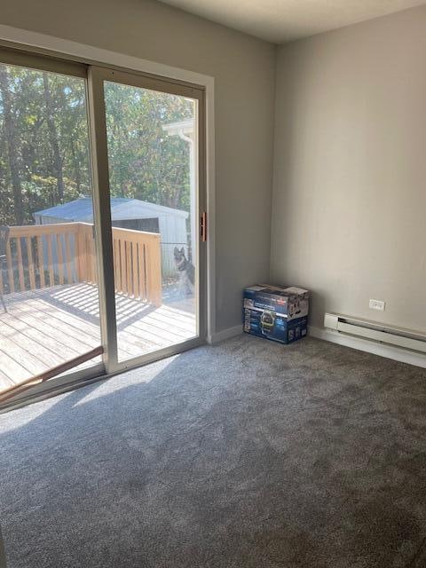 carpeted spare room with baseboard heating