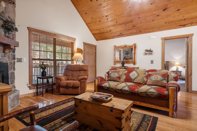 living room with wood ceiling, a fireplace, high vaulted ceiling, and light hardwood / wood-style flooring